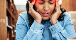 Stressed woman holding her head in a library, surrounded by books and notes, reflecting the pressures of academic life.