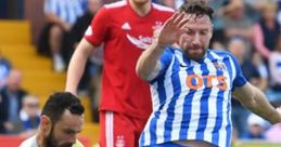 Dramatic football action between players, capturing a key moment of Aberdeen FC in a competitive match.