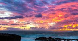 Vibrant sunset over rocky coastline, reflecting stunning colors in tidal pools, creating an amazing coastal landscape.