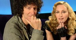 Howard Stern and Madonna sharing a candid moment on set, showcasing their unique personalities and dynamic chemistry.