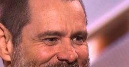 Jim Carrey smiling with a beard at the Golden Globes, reflecting on his comedic legacy from Dumb and Dumber.