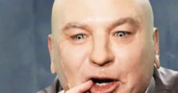 Dr. Evil character, bald with a mischievous expression, gestures playfully while dressed in a gray suit.