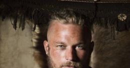 Viking warrior in traditional attire, showcasing a fierce expression and striking blue eyes, set against a rustic backdrop.