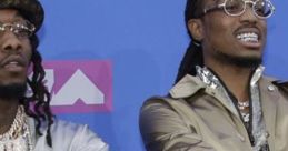 Offset and Quavo showcase their flashy style with jewelry at the MTV VMAs, highlighting their iconic rap presence.