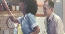 Controversial Gillette advert scene featuring a woman in a blue dress and a man reaching towards her in a kitchen setting.