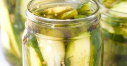 Freshly pickled cucumbers in a jar with spices, dill, and brine, showcasing a vibrant and flavorful preserve option.