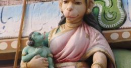 Anjanadevi holding baby Hanuman, showcasing intricate details and vibrant colors in traditional sculpture art.