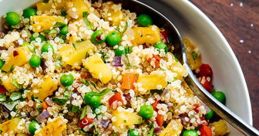 Colorful quinoa salad with pineapple, peas, and bell peppers, perfect for a healthy meal. Ideal for Raisin Bran advertising.