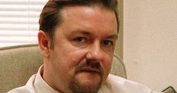 David Brent gestures playfully in an office setting, embodying humor from the "Prank Call" scene.