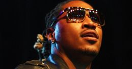 Future performing on stage, wearing sunglasses and a leather jacket, showcasing style and confidence in hip-hop culture.