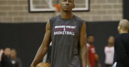 Ray Allen in Miami Heat gear holding a basketball, showcasing focus during an NBA training session.