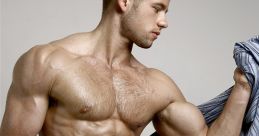 Muscular man in blue underwear striking a pose, showcasing fitness and confidence with a stylish shirt draped over his shoulder.