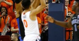 Basketball action shot featuring players in a competitive game, with fans and musicians supporting in the background.