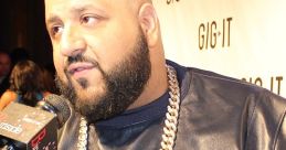 DJ Khaled attends an event wearing a stylish leather outfit and a large gold chain, showcasing his iconic fashion sense.