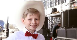 Smiling young boy in cowboy hat and bow tie, embodying the spirit of yodeling and country music culture.