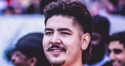 YouTuber smiling in a red soccer jersey at a lively event, showcasing a fun spirit and engaging community atmosphere.