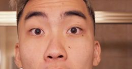 Surprised expression of RiceGum in a bathroom setting, showcasing his distinct style and engaging personality.