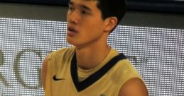 George Washington University basketball player in gold uniform, number 12, during a game, focused on the action.