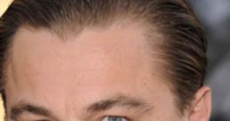 Close-up of Leonardo DiCaprio's face showcasing his striking blue eyes and stylish slicked-back hair at a premiere event.