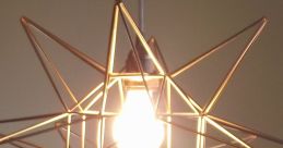 Star-shaped gold chandelier with a bright bulb, adding modern flair and artistic illumination to any room.