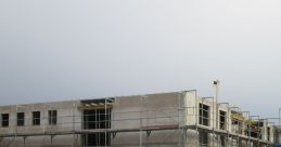 Construction site showcasing scaffolding and building progress, reflecting the development of modern housing for families.