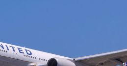 United Airlines Boeing 777 aircraft approaching for landing against a clear blue sky, showcasing its landing gear and wing design.