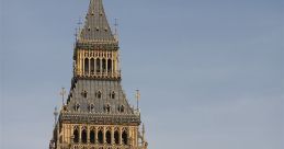 Iconic view of Big Ben against a blue sky, showcasing its intricate clock design and Gothic architecture.