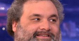 Artie Lange laughing during a talk show interview, showcasing his comedic charm and engaging personality.