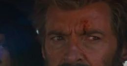 Logan, with a rugged look and scars, gazes intensely from a vehicle, embodying the iconic Wolverine character.