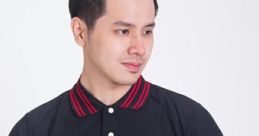 Young man in a stylish black polo shirt with red accents, showcasing modern fashion by Kaos. Effortlessly cool look.