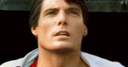 Christopher Reeve as Superman, showcasing the iconic blue and red costume with the Superman logo, gazing upward heroically.