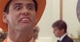 Jim Carrey in an iconic orange suit, capturing the comedic essence of "Dumb and Dumber" with a memorable expression.