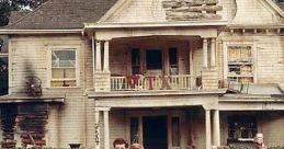 Group of college students celebrating in front of the iconic house from the classic film Animal House.