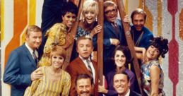 Cast of the classic "Laugh-In" TV show posing in vibrant outfits, showcasing the humor and style of the iconic series.