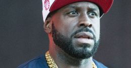 Funkmaster Flex showcasing style with gold chains and a cap, embodying street culture and music influence.