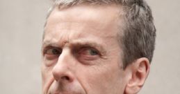 Malcolm Tucker's intense gaze in formal attire, embodying the sharp wit of "In The Loop" and "The Thick of It.