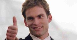 Stifler from American Pie giving a thumbs up, dressed in a stylish suit with a confident smile. Iconic movie moment.