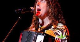 Weird Al" Yankovic passionately performs with an accordion, wearing a colorful shirt against a vibrant stage backdrop.