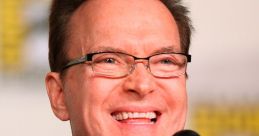 Billy West laughing during a panel discussion, showcasing his vibrant personality and engaging presence in entertainment.