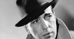 Classic black and white portrait of Humphrey Bogart in a stylish hat and coat, exuding 1940s Hollywood charm.