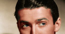 Classic portrait of James Stewart, showcasing his signature charm with a tuxedo and captivating blue eyes.