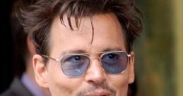 Johnny Depp sporting stylish sunglasses and a chic outfit, exuding charisma and charm at a public appearance.