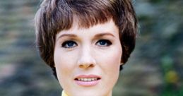 Portrait of Julie Andrews with short hair, wearing a yellow zip-up top, exuding classic 1960s elegance and charm.