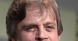 Mark Hamill smiling during a panel discussion, showcasing his iconic look and engaging personality.