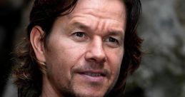 Mark Wahlberg in casual attire, showcasing his signature style and charismatic expression outdoors.