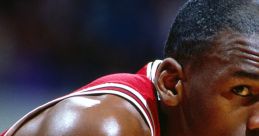 Michael Jordan in a red Chicago Bulls jersey, showcasing focus and determination on the basketball court during a game.