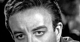 Close-up of Peter Sellers, showcasing his intense expression and classic hairstyle in a monochrome portrait.