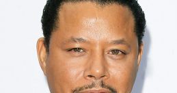 Terrence Howard in a stylish blue suit and tie, showcasing his signature grooming and confident expression at an event.