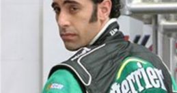 Jean Girard in a green racing suit with Perrier branding, showcasing his confident demeanor at the racetrack.