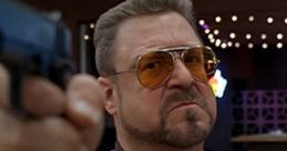 Walter Sobchak aiming a gun with a fierce expression, showcasing his intense personality and iconic bowling scene.